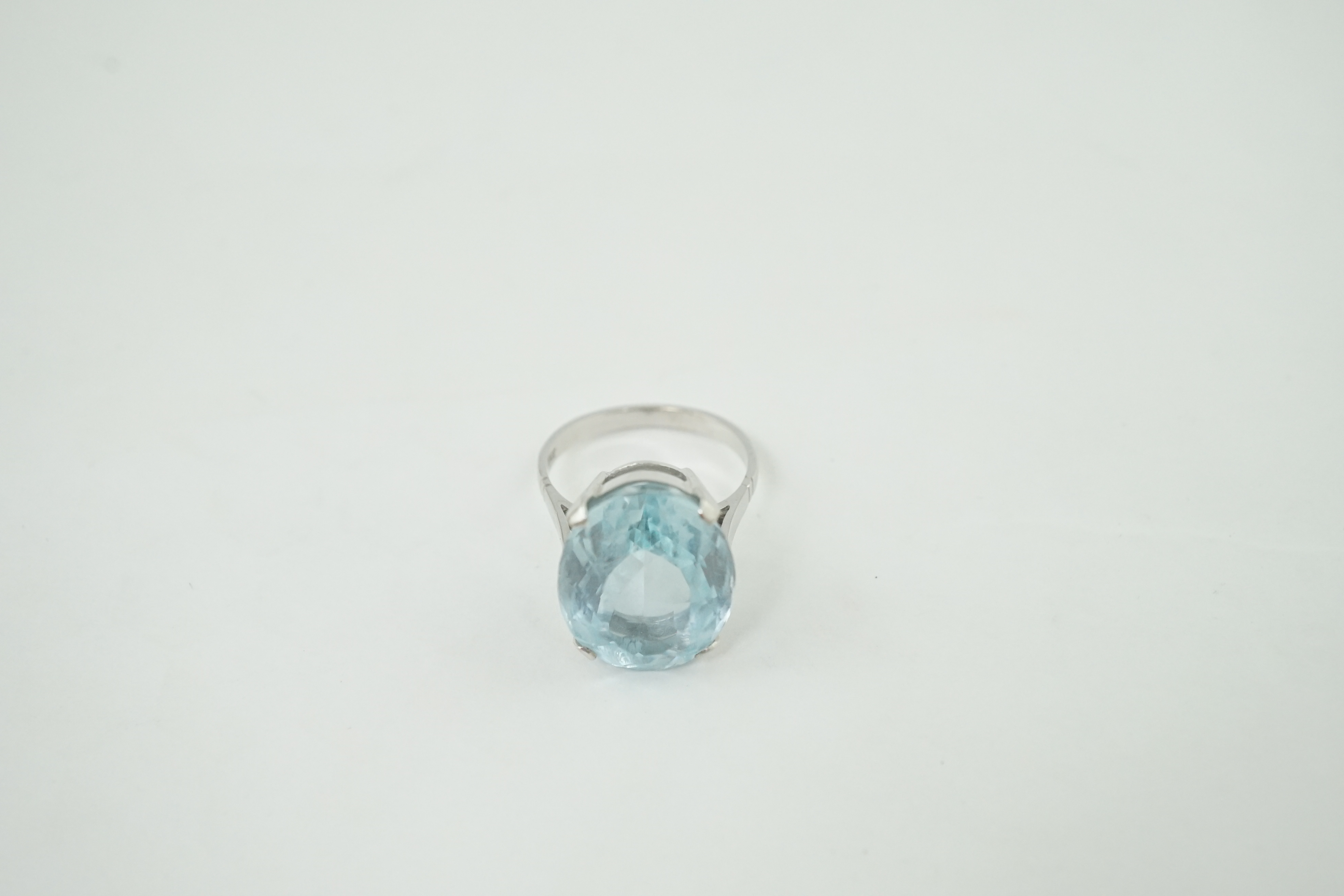 A mid 20th century 18ct white gold and single stone oval cut aquamarine set dress ring